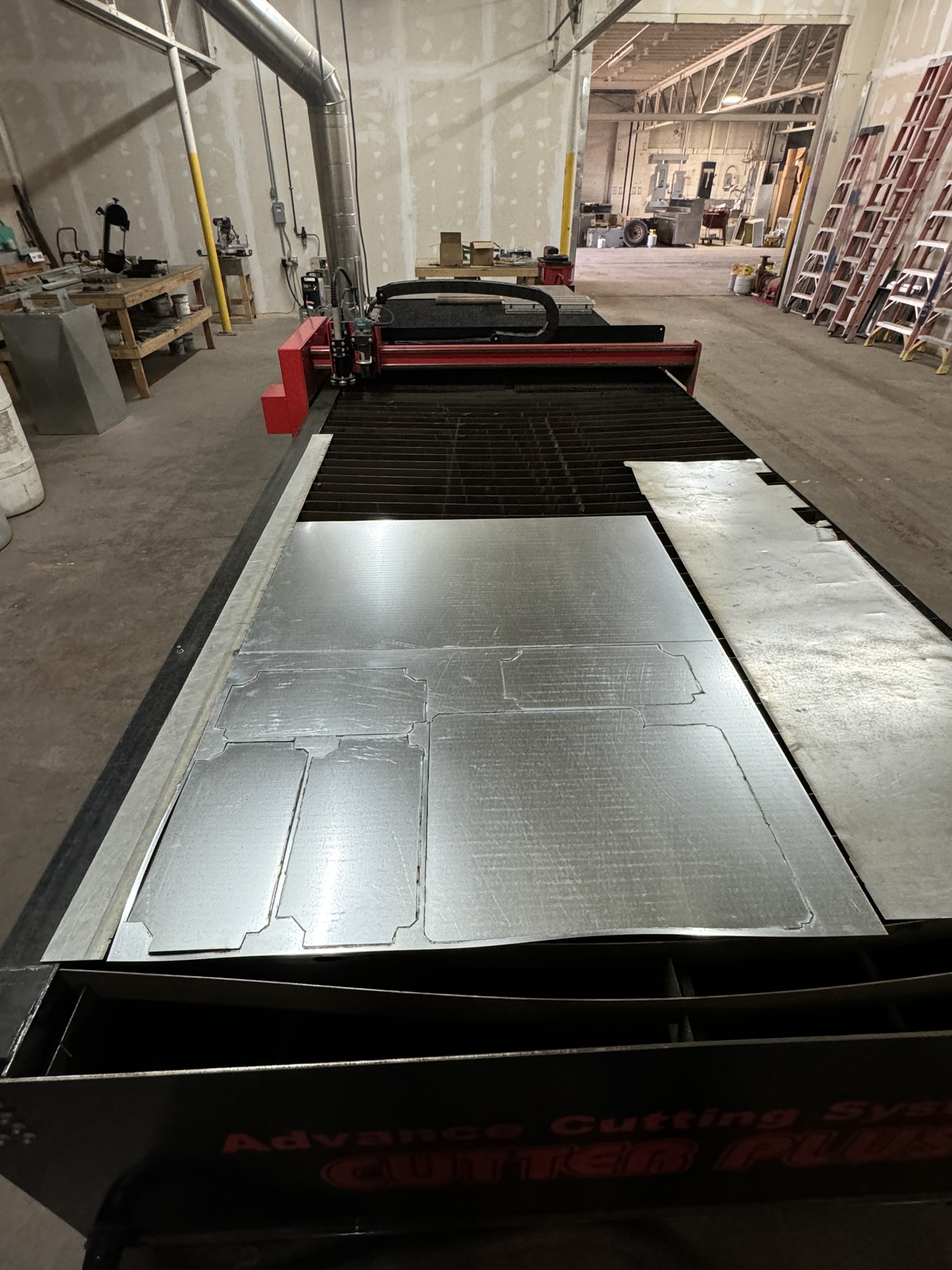Cut sheet metal panels on a fabrication table